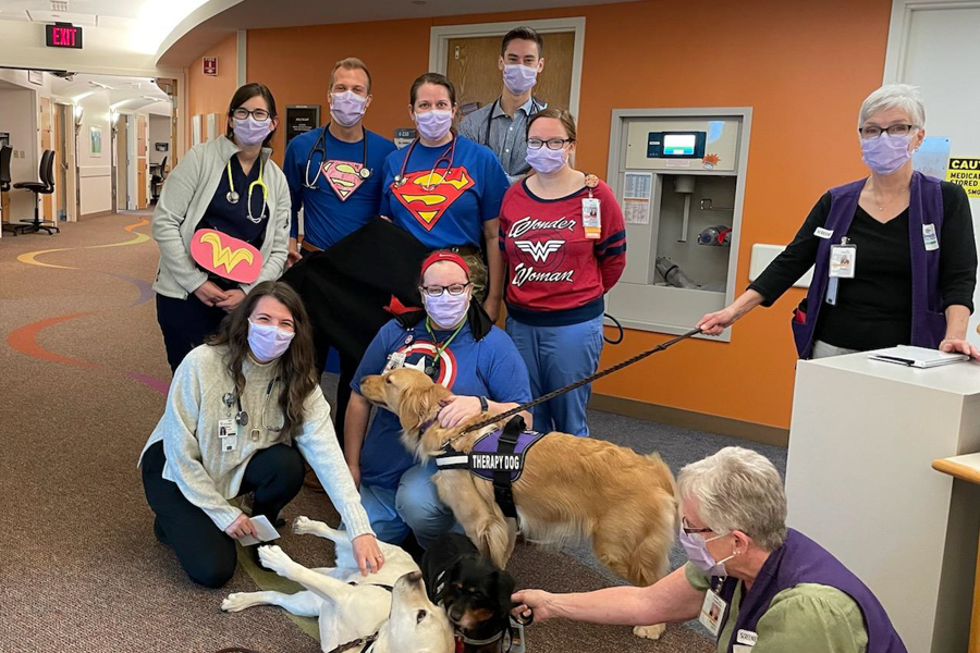 residents posing for photo with hospital dog