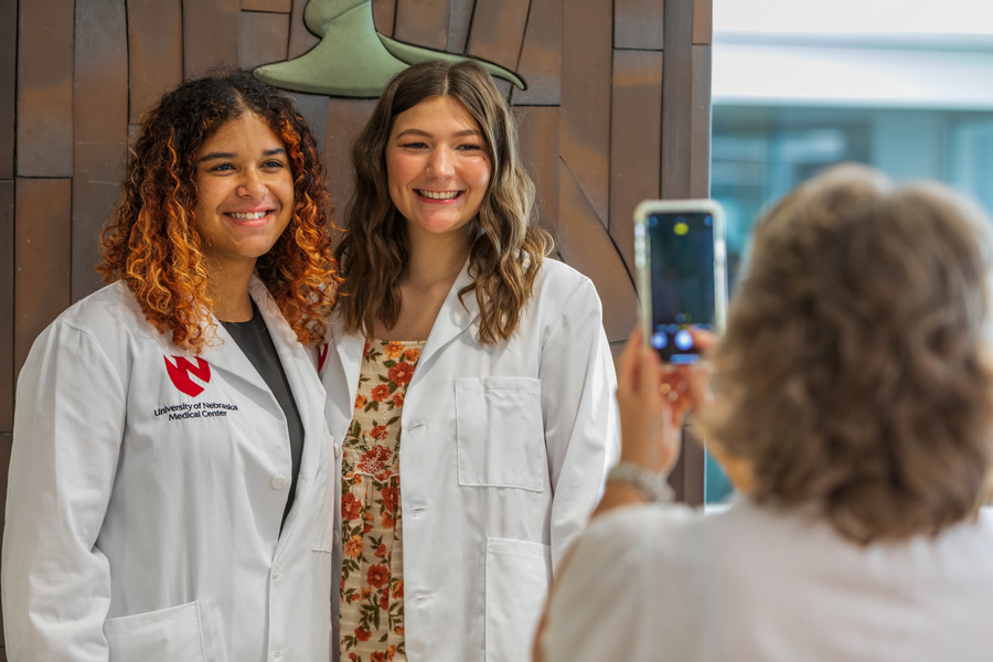 students at white coat ceremony posing for photo