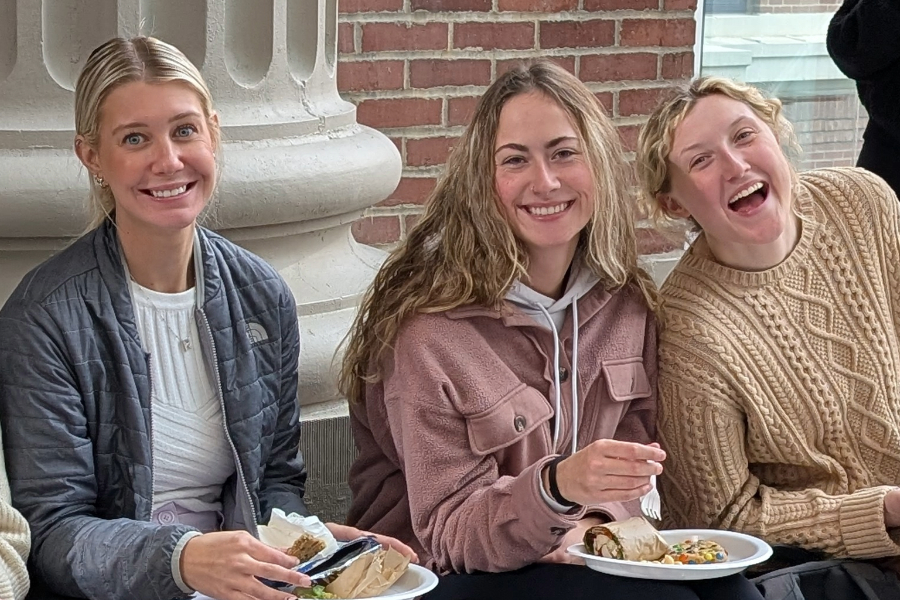 seated students smiling at camera