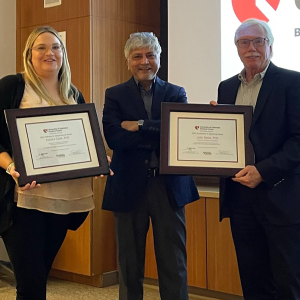 Award winner and mentor pose holding their awards