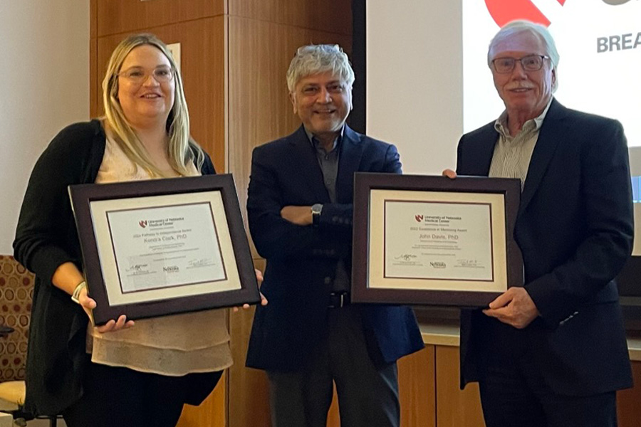 Postdoc and mentor pose with their awards