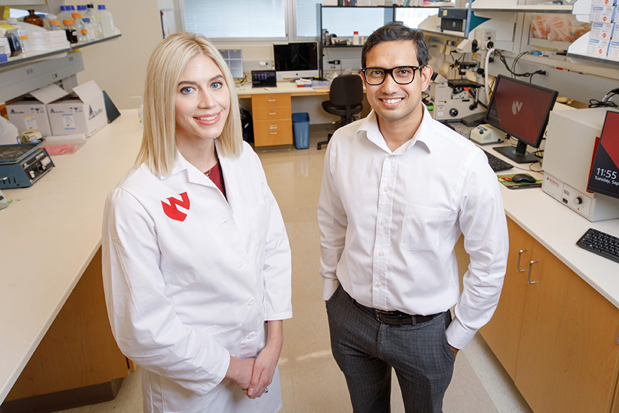 Two postdocs pose in the lab