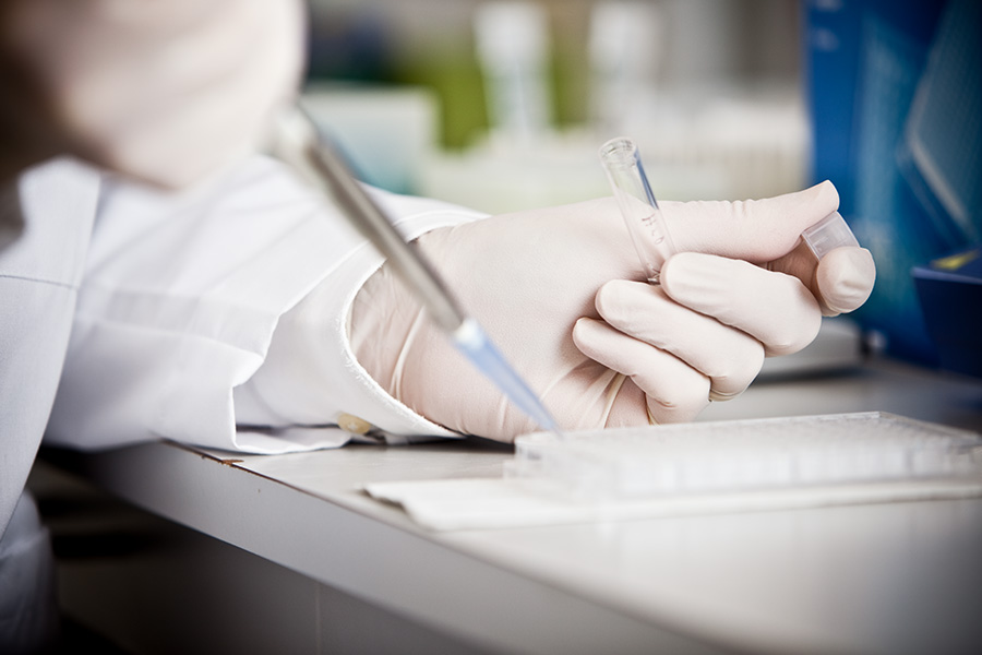 Person working with liquid samples in the lab