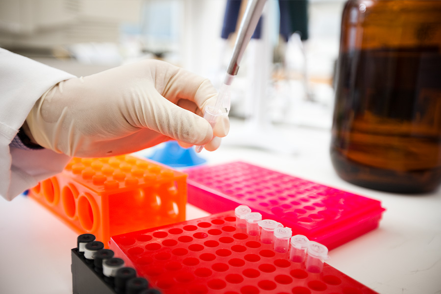 Person doing lab research with small vials