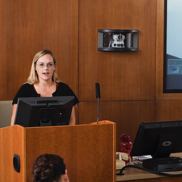 A professor instructing behind a podium.