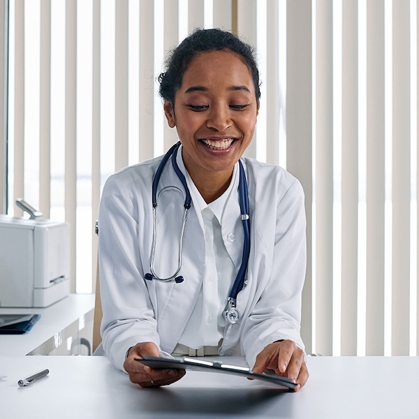 A practitioner smiling at her clipboard.