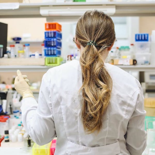 A student standing in a lab.