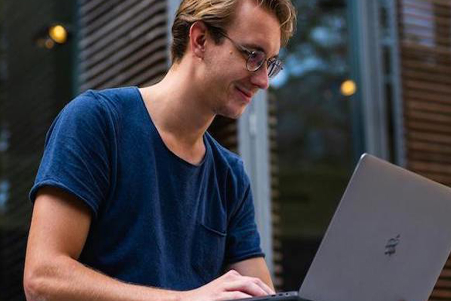 Man looking at open laptop