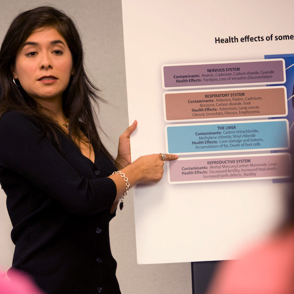 A professor standing in front of a diagram.