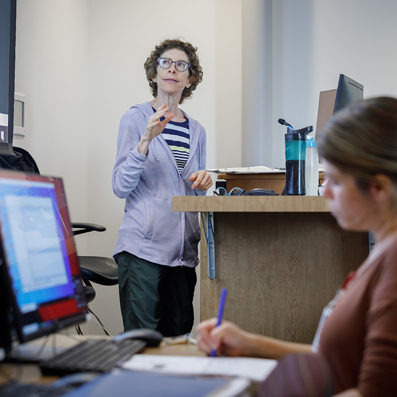 Woman presenting at a podium.