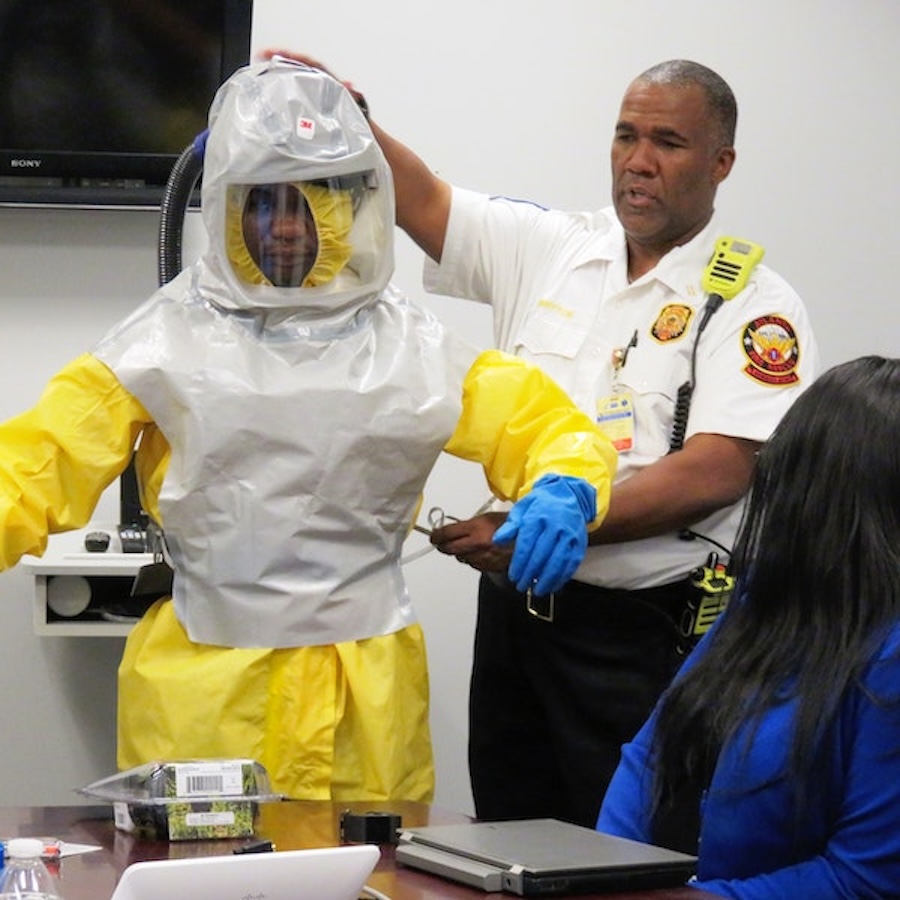 A first responder demonstrating safety equipment.