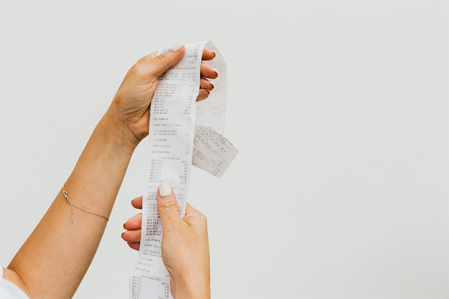 Holding up shopping receipt