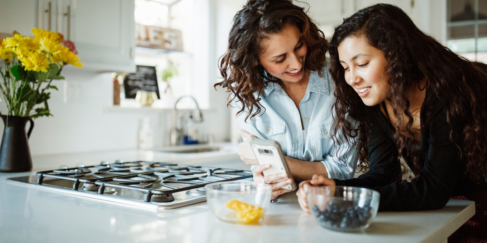 Large hero - Parent and teen leaning on kitchen counter talking
