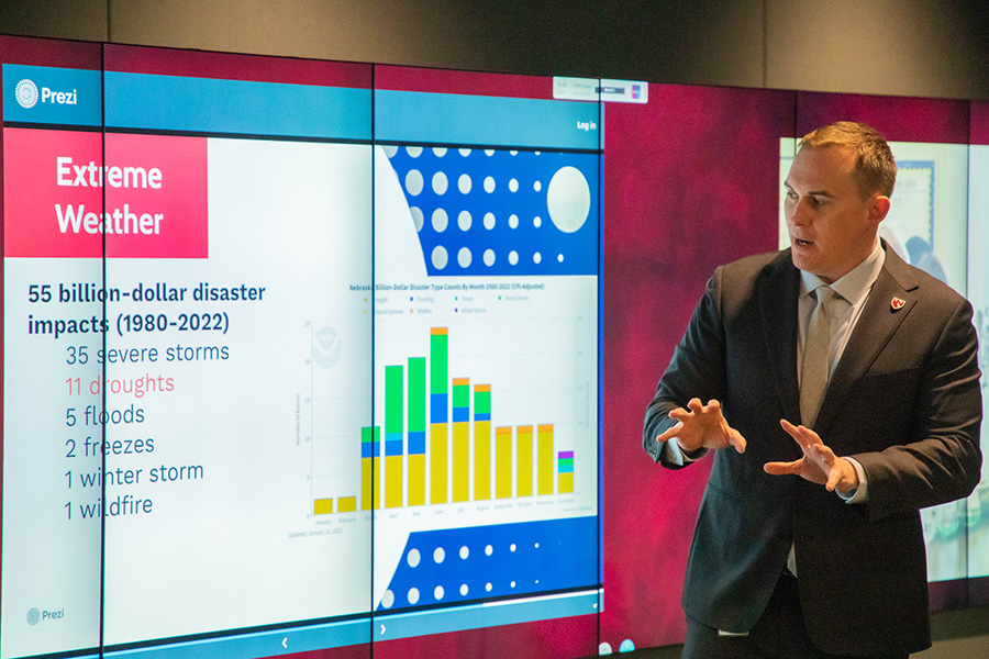 Image of Dr. Jesse Bell pointing to a presentation on a screen.