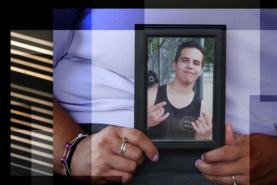 CLose up of woman holding a photograph of Derrek Cocchiarella.