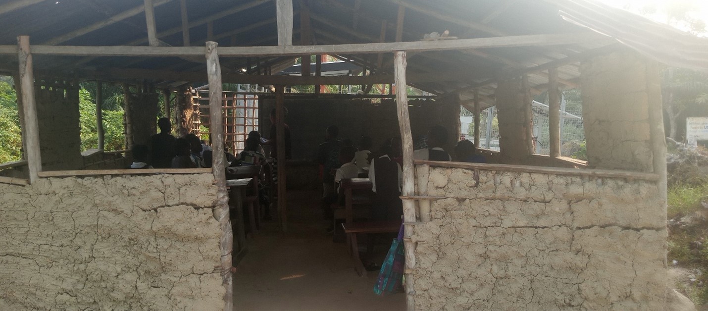 Image on an open-air school classroom with students inside.