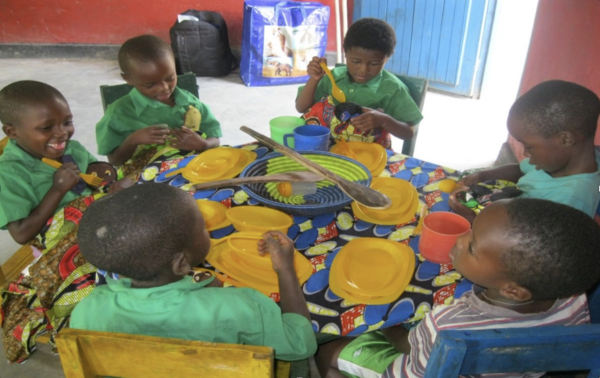 Image of children sitting around a table doing arts and crafts.