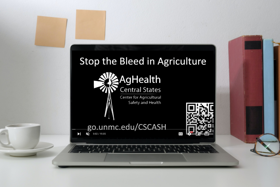 Computer with video on screen titled "Stop the Bleed in Agriculture"