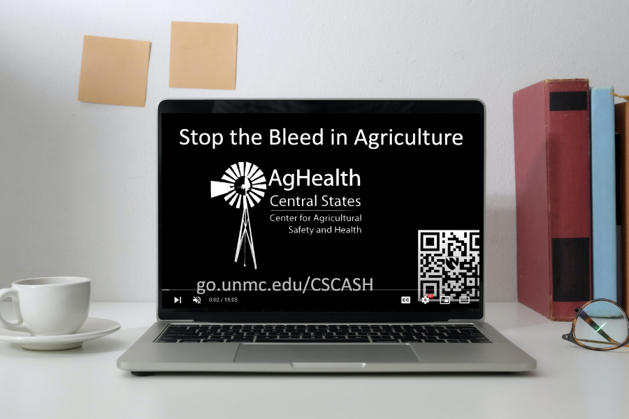 Laptop open to video with "Stop the Bleed in Agriculture" heading.