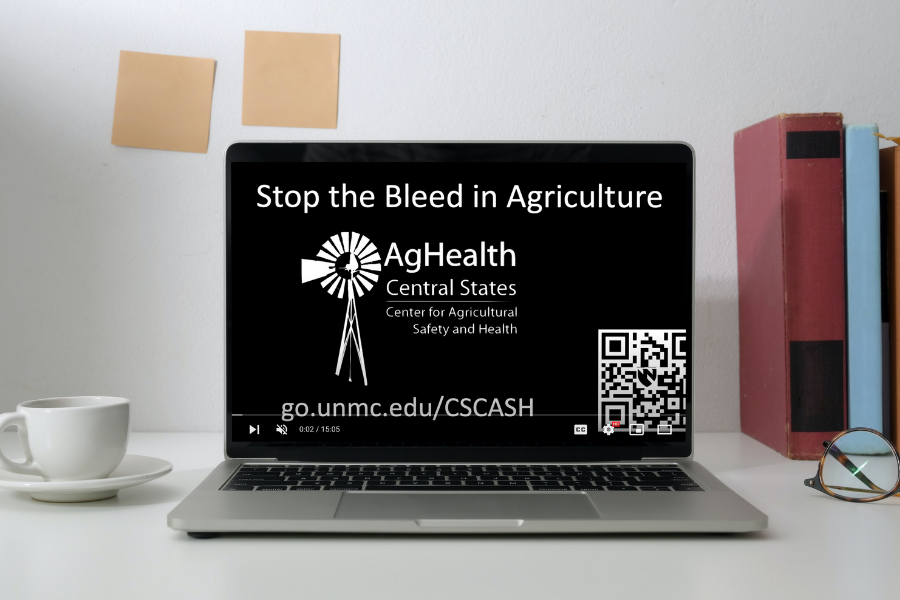 Laptop open to video with "Stop the Bleed in Agriculture" heading. 