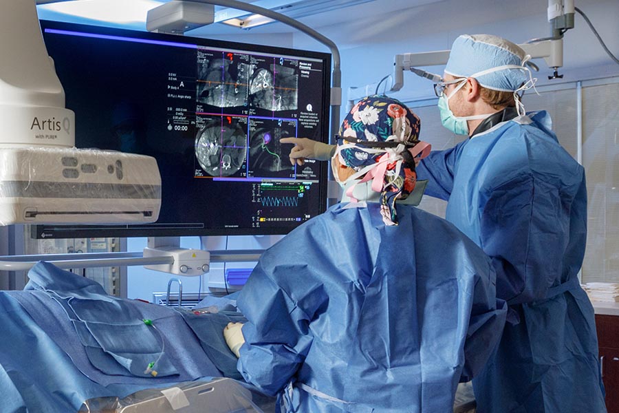 Radiologists read scans during a procedure.
