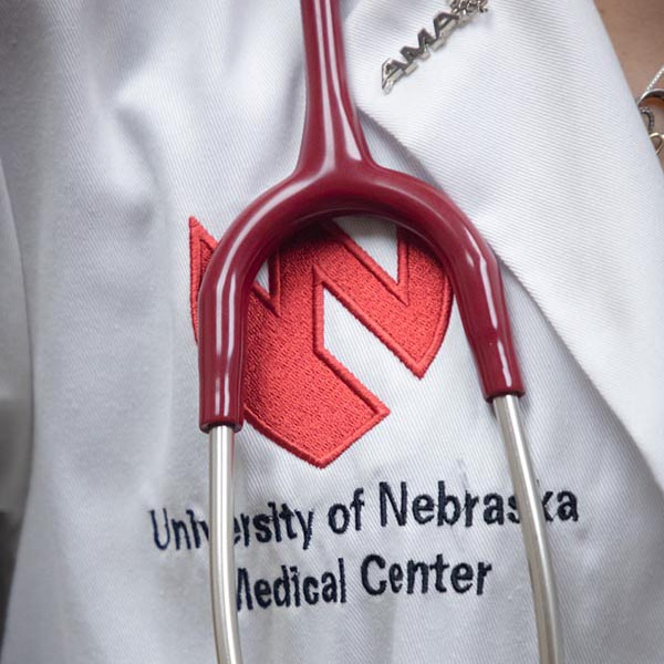 UNMC logo on a white coat