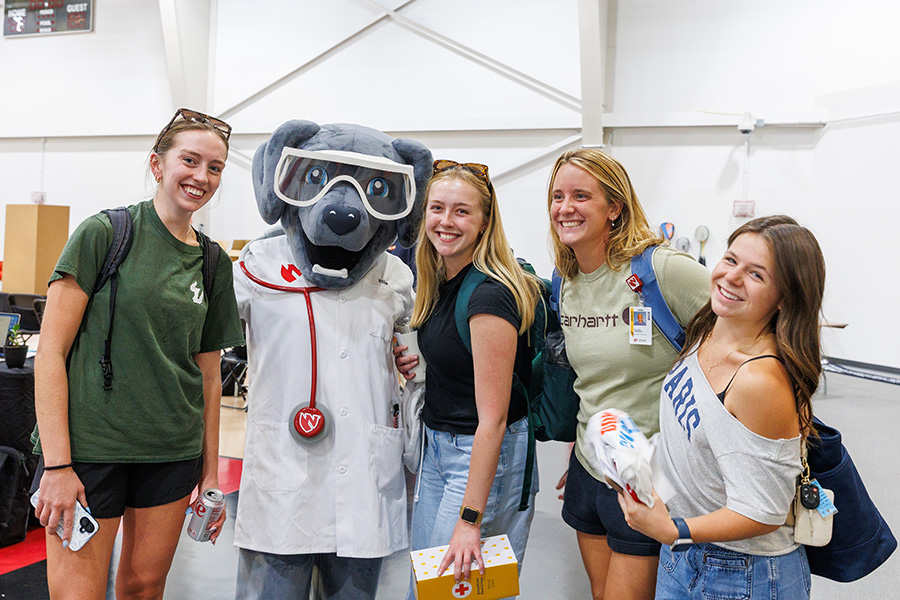 students at involvement fair with Ellie the mascot