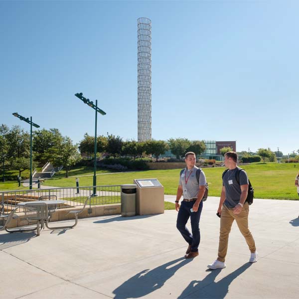 Two men walk on the UNMC campus