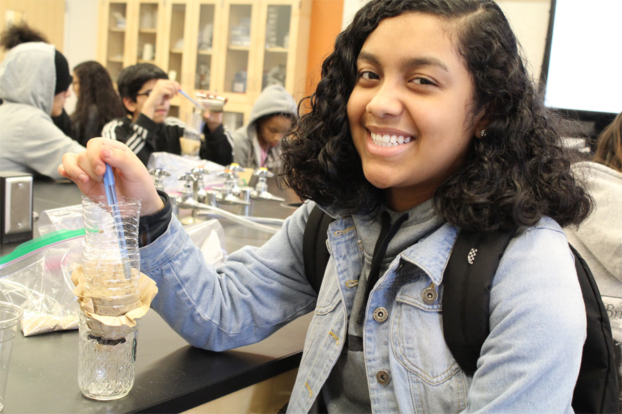 A middle school student participates in a science experiment