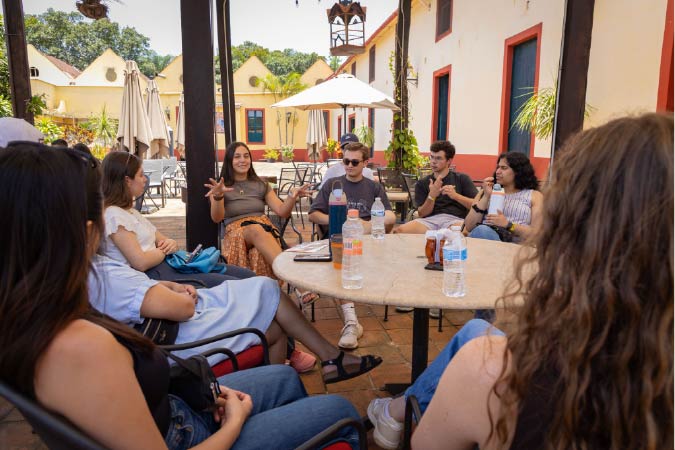 students sitting at a table outdoors