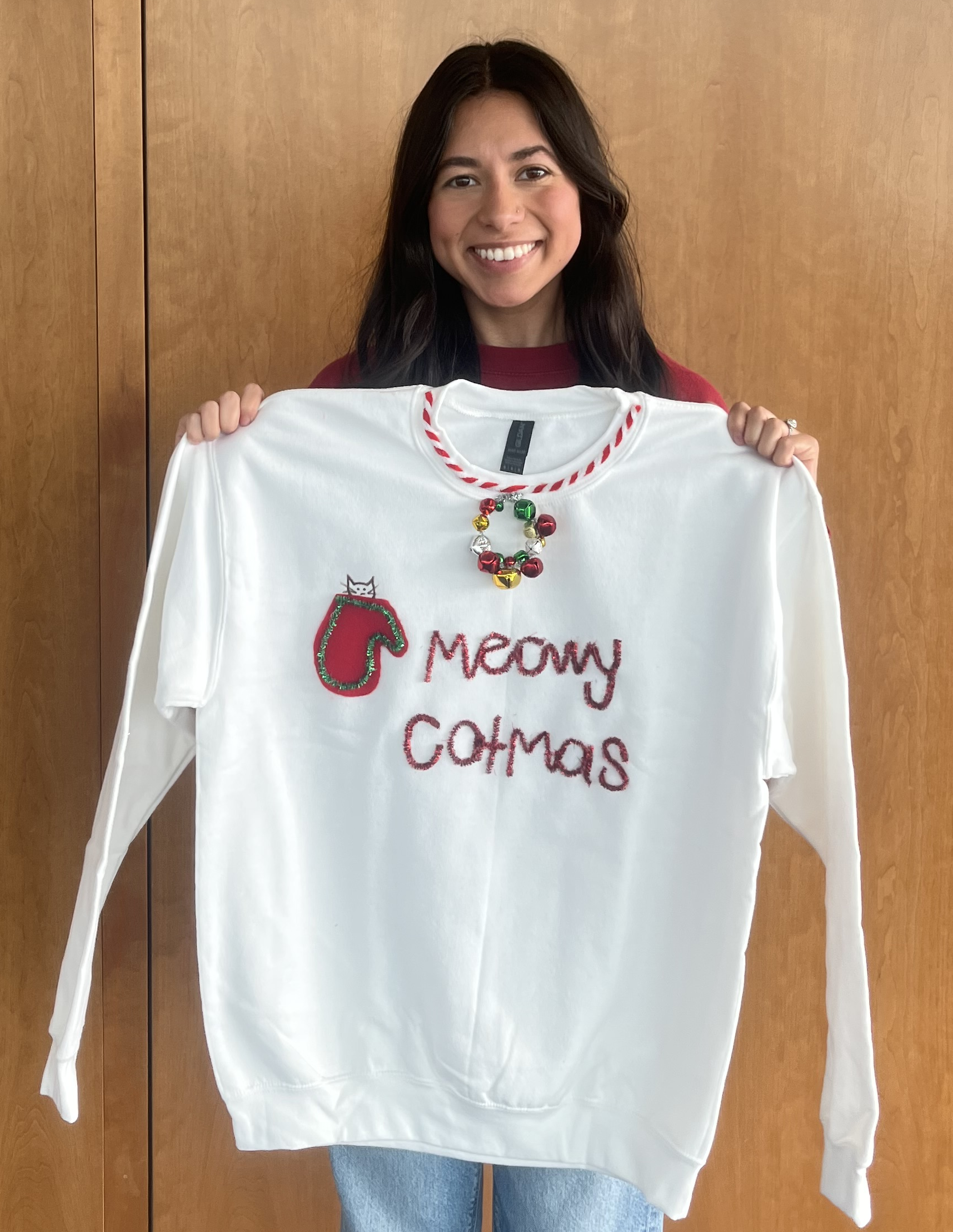 student with her sweater showing a cat peeking out of a stocking
