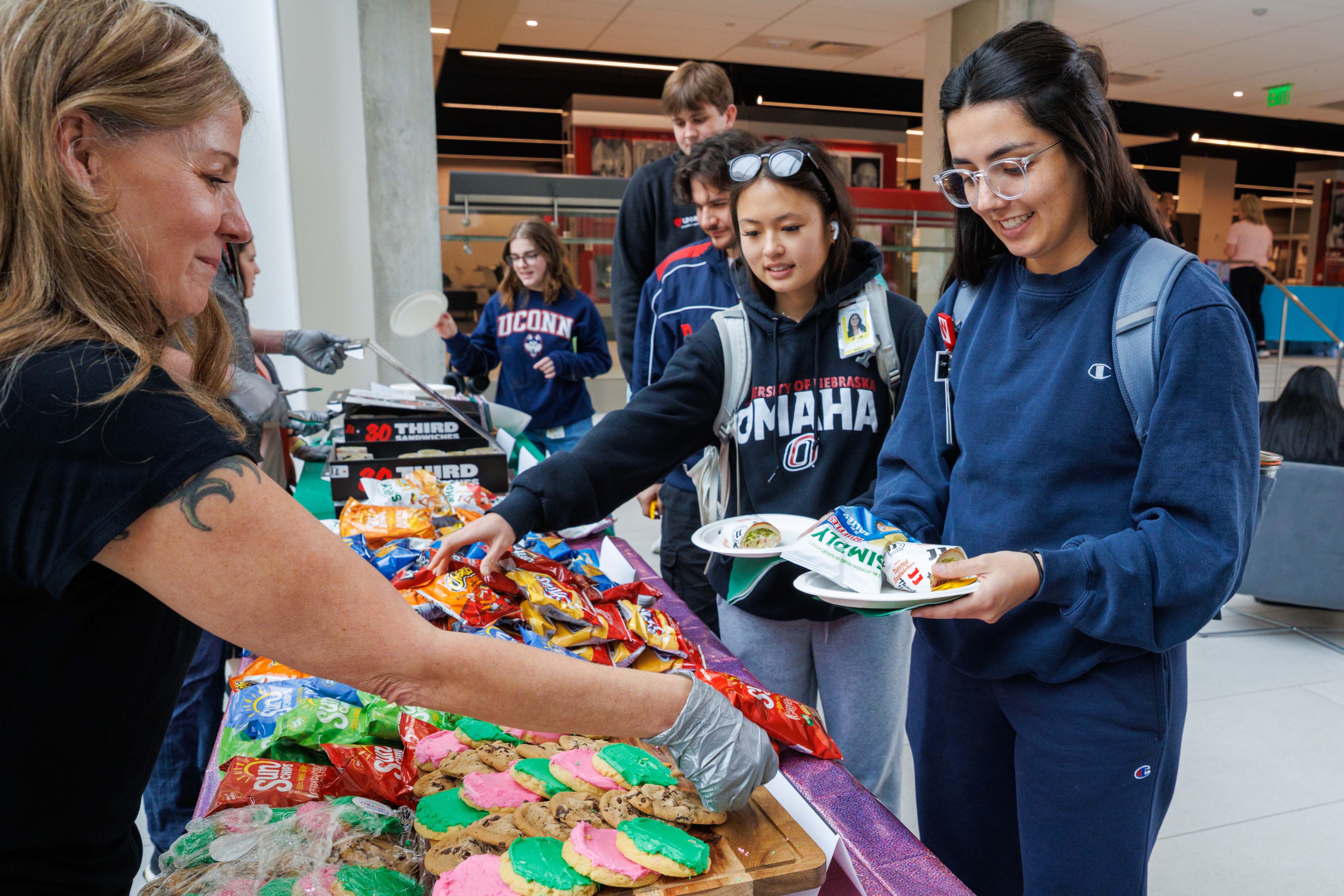 Students enjoy snacks like cookies and chips at a de-stress event