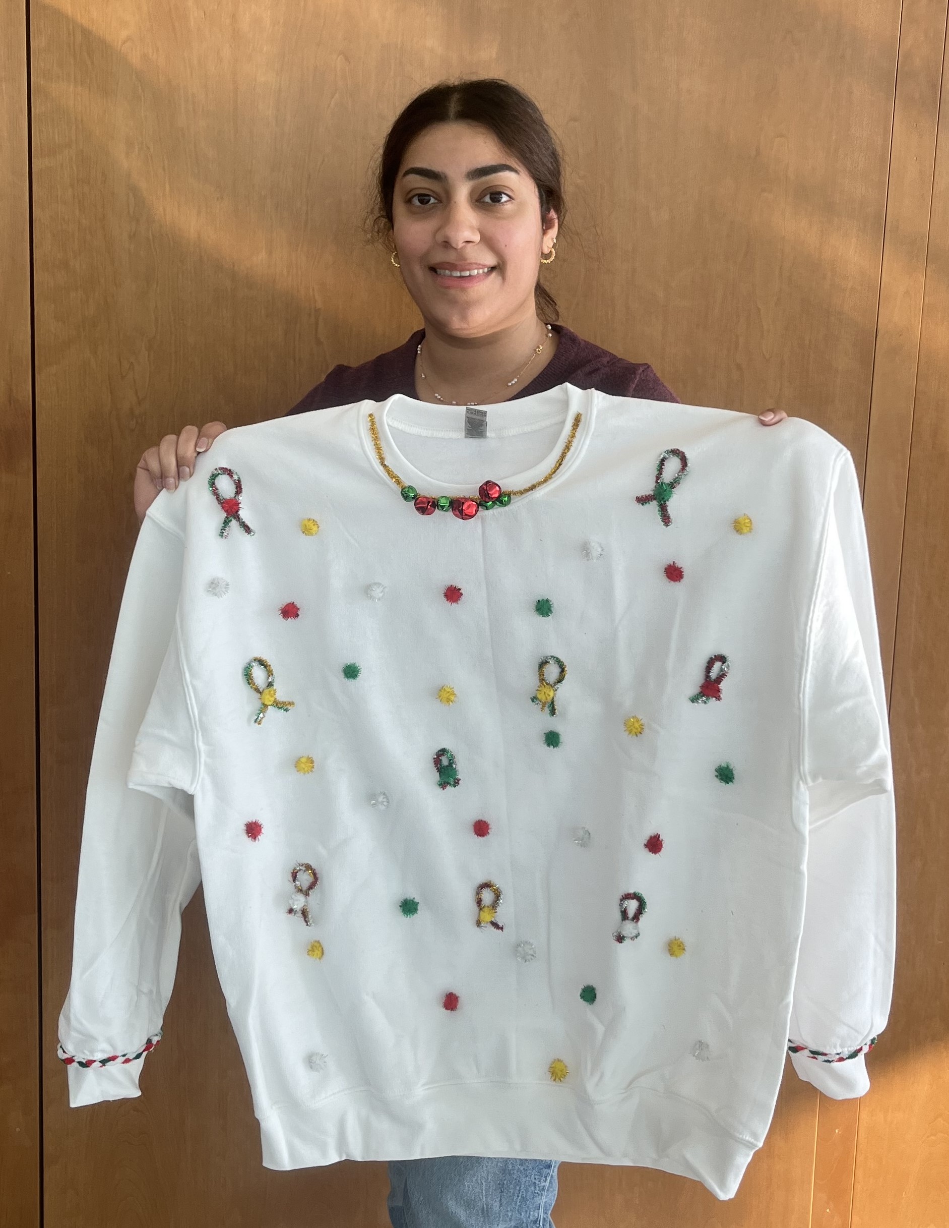 student with her sweater decorated with snowflakes and hope ribbons