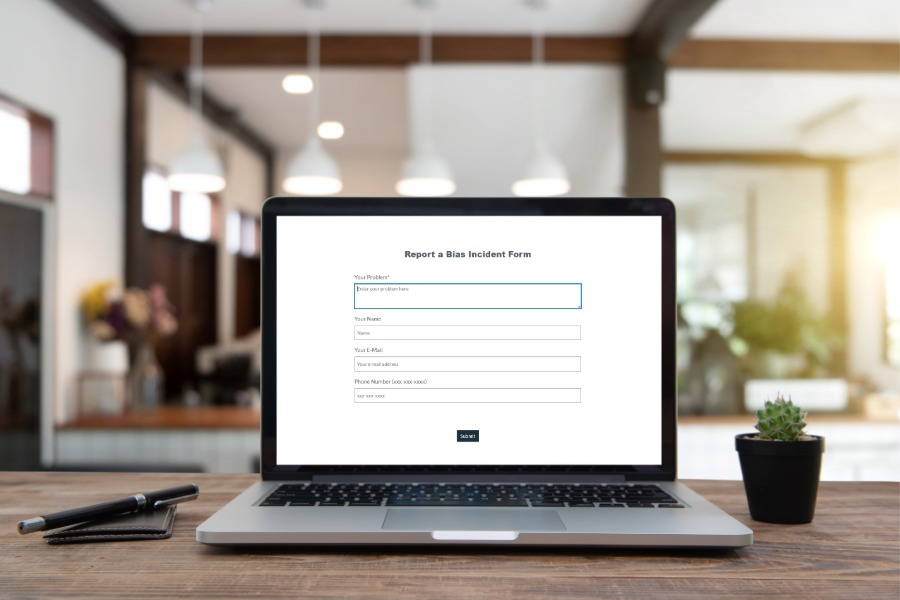 laptop computer with bias reporting form showing on the screen