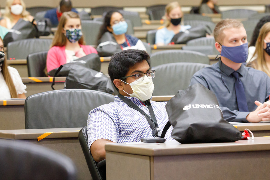 A group of students sit in a lecture hall