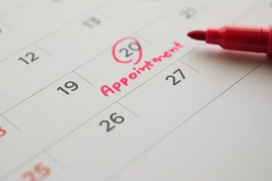 A date is circled on a desk calendar next to the word "appointment"