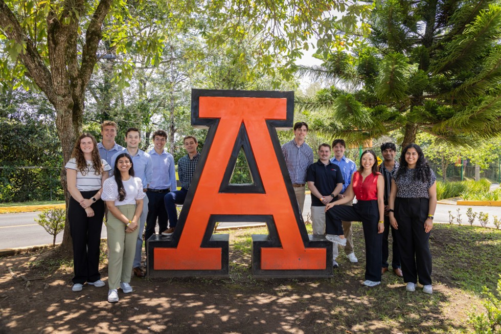students standing by the A statue at Anahuac University