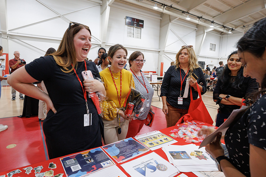 students visit the International Student Association table at the involvement fair