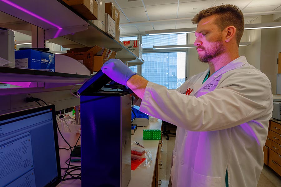 Dr. Christopher Barrett performs an experiment in his lab.