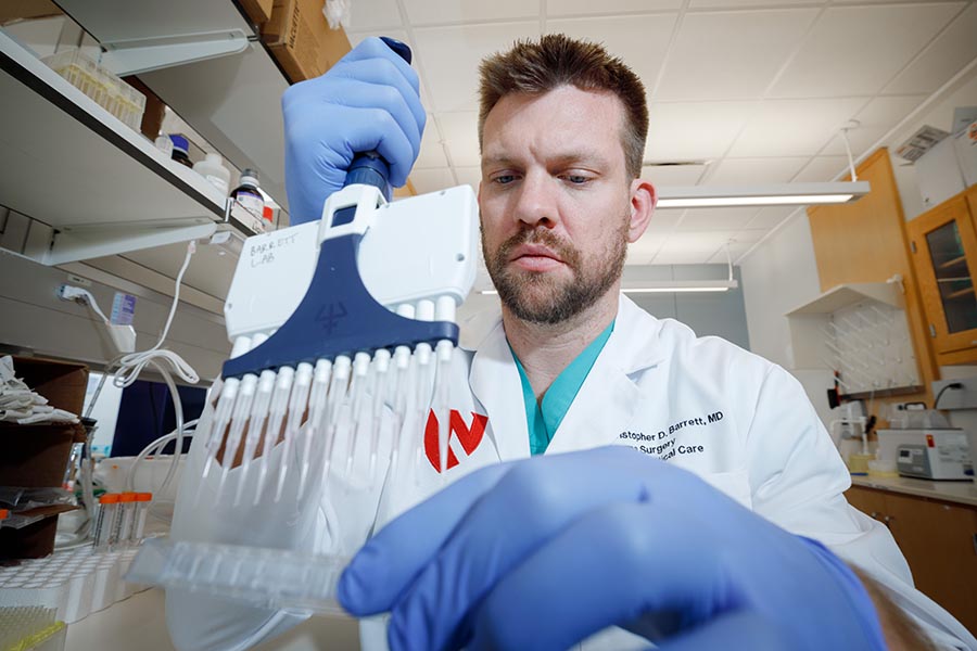 Dr. Christopher Barrett conducts experiments in his clinical lab.