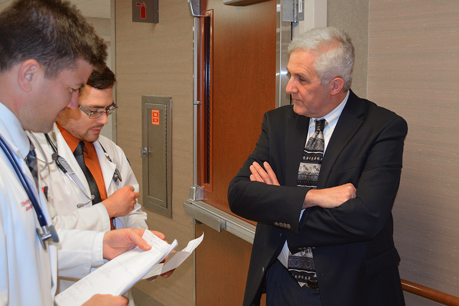 Dr. Jon S. Thompson talks with residents