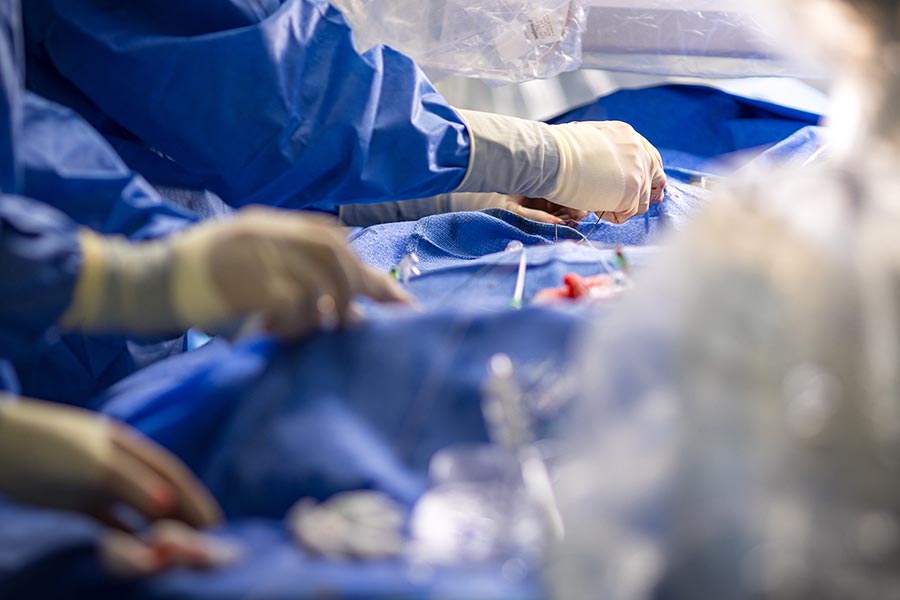 Close up photo of hands performing surgery.