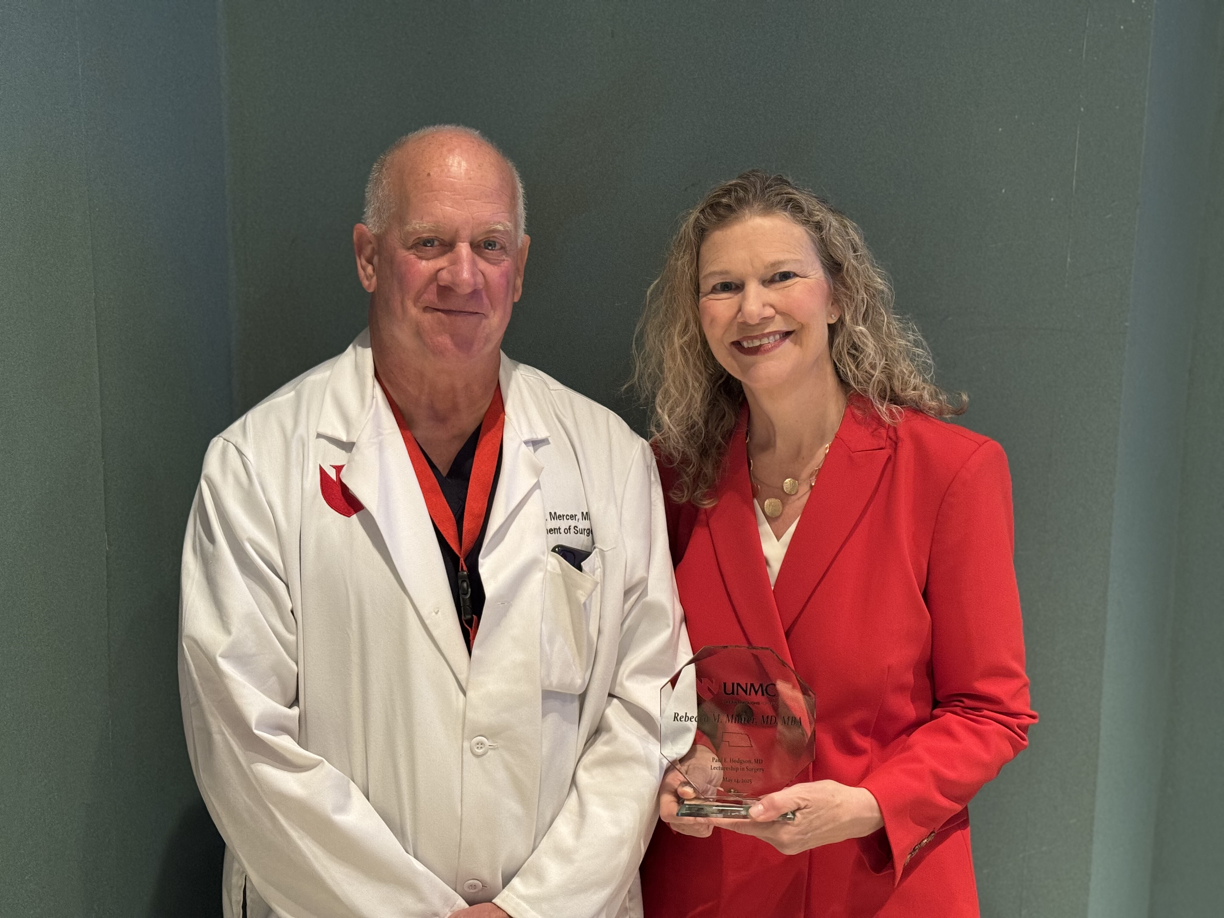 Dr. Mercer presents Dr. Minter with a plaque.