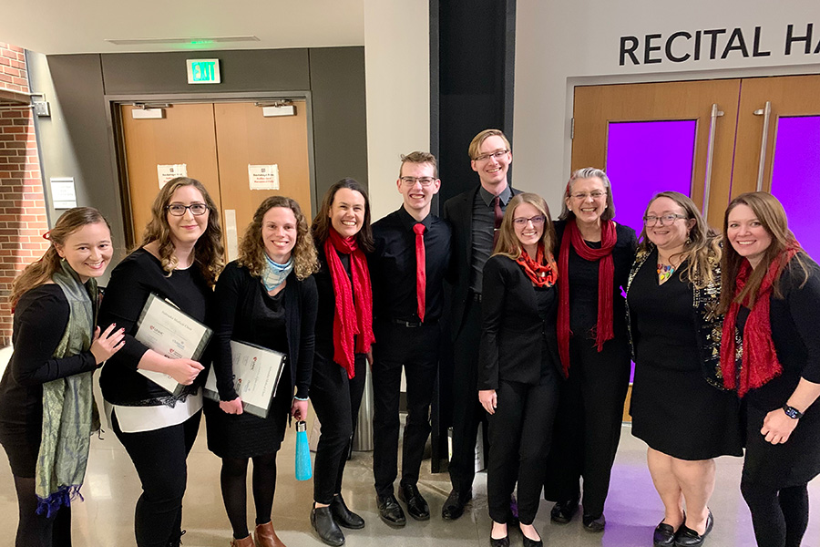 members of the choir posing outside the recital hall