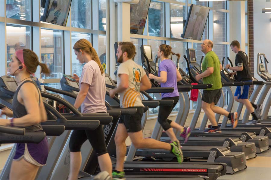 A group of people run on treadmills in the Center for Healthy Living